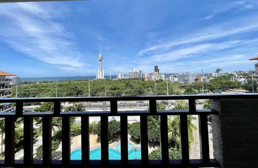 Balcony view overlooking city skyline and swimming pool