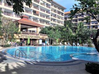 Apartment complex with swimming pool and tropical trees