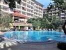 Apartment complex with swimming pool and tropical trees