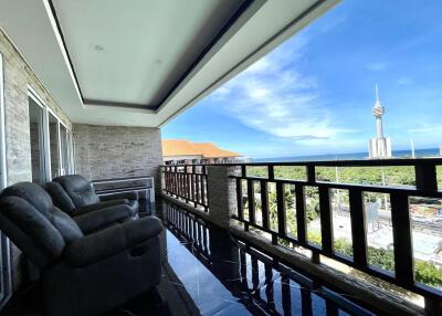 Spacious balcony with a view of the city skyline and comfortable seating