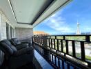 Spacious balcony with a view of the city skyline and comfortable seating