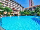 Residential building with large outdoor swimming pool and palm trees