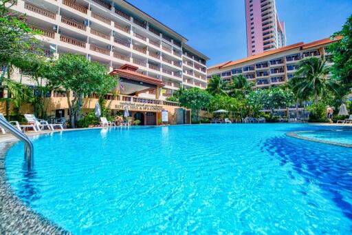 Residential building with large outdoor swimming pool and palm trees