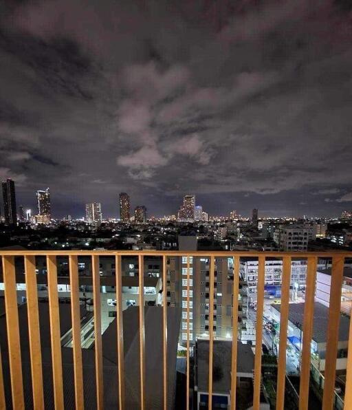 City view from a high-rise apartment balcony at night