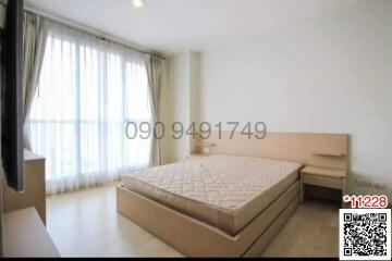 Spacious bedroom with a large bed and ample natural light