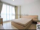 Spacious bedroom with a large bed and ample natural light