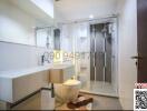 Modern bathroom with glass shower enclosure and vanity