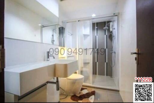 Modern bathroom with glass shower enclosure and vanity