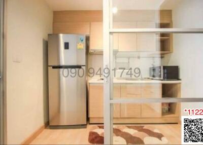 Modern kitchen with wooden cabinets and stainless steel refrigerator