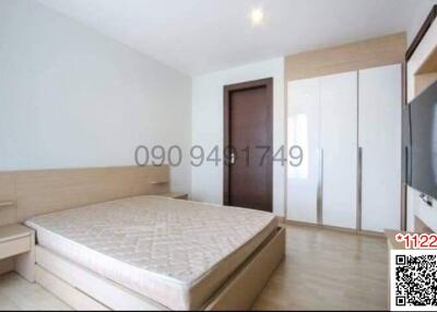 Spacious bedroom with large bed and built-in wardrobes