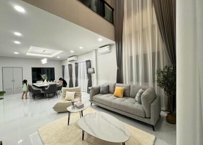 Spacious and modern living room with dining area and ample lighting