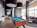 Spacious living room with high ceiling and pool table