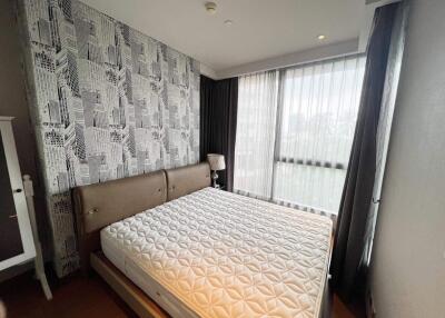 Modern bedroom with city-themed wallpaper and ample natural light