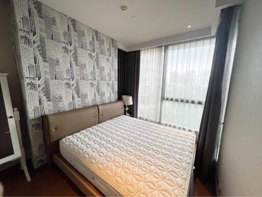 Modern bedroom with city-themed wallpaper and ample natural light