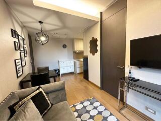 Modern living room with kitchen in the background