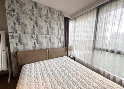 Modern bedroom with city pattern wallpaper and large window