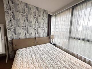 Modern bedroom with city pattern wallpaper and large window