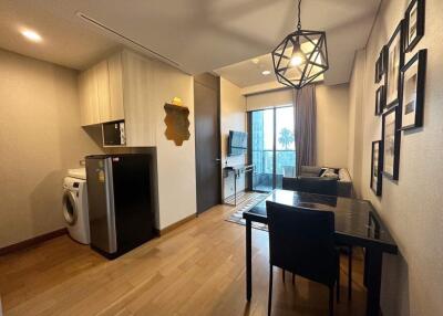 Modern living and dining area with kitchen appliances and balcony access