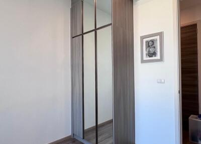 Minimalist bedroom interior with sliding door wardrobe and air conditioner