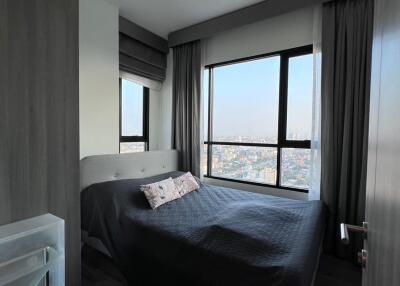 Modern bedroom with a large window offering an expansive view