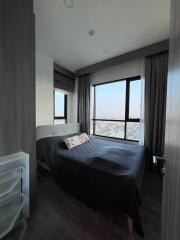 Modern bedroom with a large window offering an expansive view