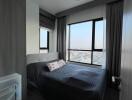 Modern bedroom with a large window offering an expansive view