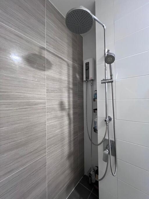 Modern bathroom with wall-mounted shower and grey tiles