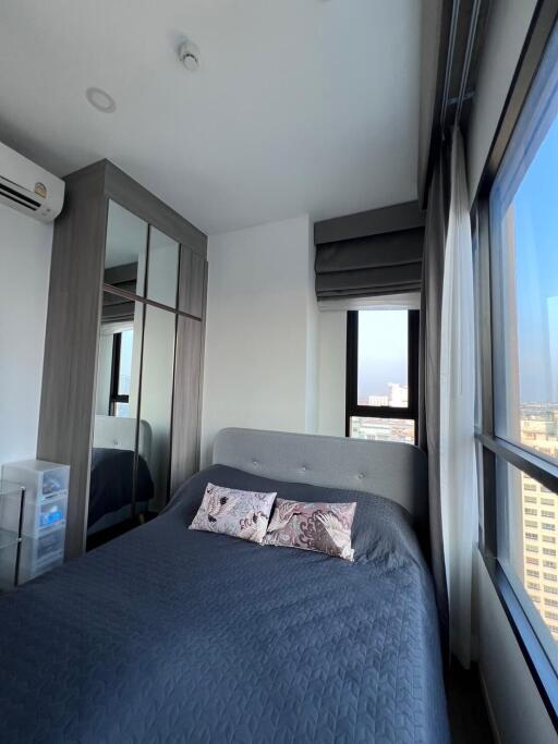 Modern bedroom with large window and city view