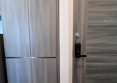 Modern wooden door with electronic lock in a contemporary building