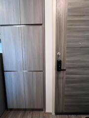 Modern wooden door with electronic lock in a contemporary building