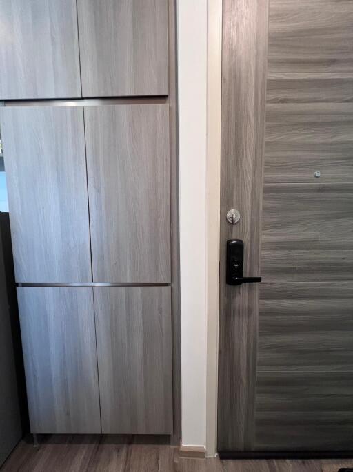 Modern wooden door with electronic lock in a contemporary building
