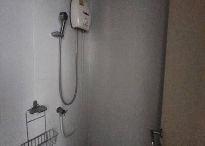 Compact bathroom with wall-mounted shower unit