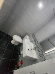 Modern bathroom with white fixtures and gray tiles