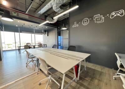 Modern office space with conference table and artistic wall decor