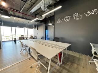 Modern office space with conference table and artistic wall decor