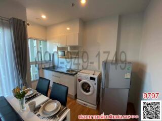 Compact kitchen with modern appliances and a small dining area