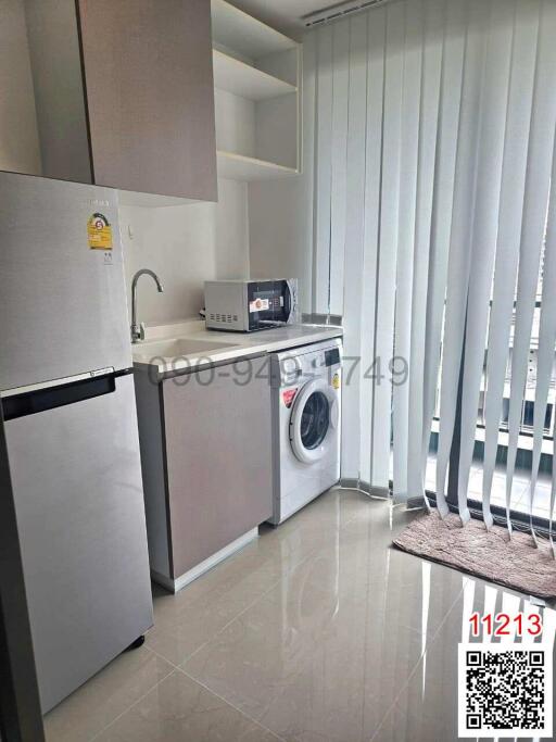 Compact kitchen with modern appliances and washing machine