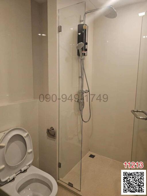 Modern bathroom interior with glass shower and toilet