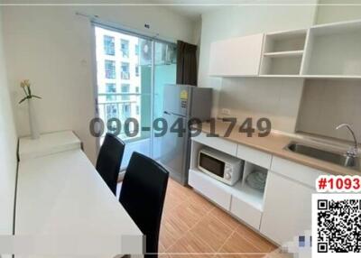 Modern compact kitchen with dining area and balcony access