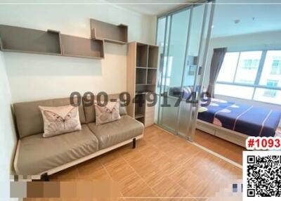 Compact bedroom with a sofa and bed, fitted shelves, hardwood flooring, and balcony access