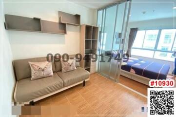 Compact bedroom with a sofa and bed, fitted shelves, hardwood flooring, and balcony access