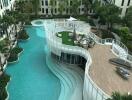 Modern residential building complex with central swimming pool and relaxing lounge area