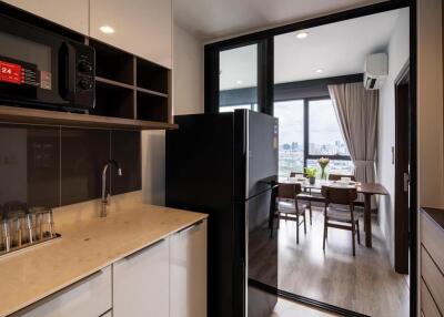 Modern kitchen with stainless steel appliances and a view of the dining area