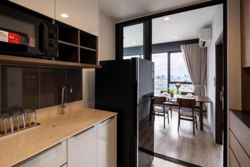 Modern kitchen with stainless steel appliances and a view of the dining area