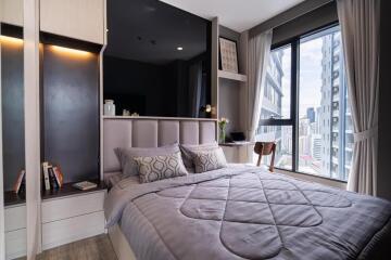 Modern bedroom interior with large window view in urban apartment