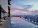 Modern rooftop pool overlooking the city skyline at dusk