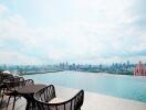 Rooftop infinity pool with city skyline view and lounge chairs