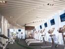 Modern gym with cardio machines overlooking the city