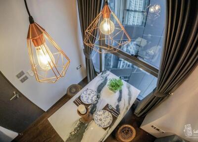 Modern dining area with stylish pendant lights and city view