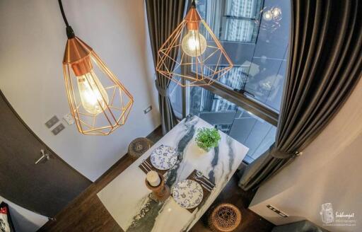 Modern dining area with stylish pendant lights and city view